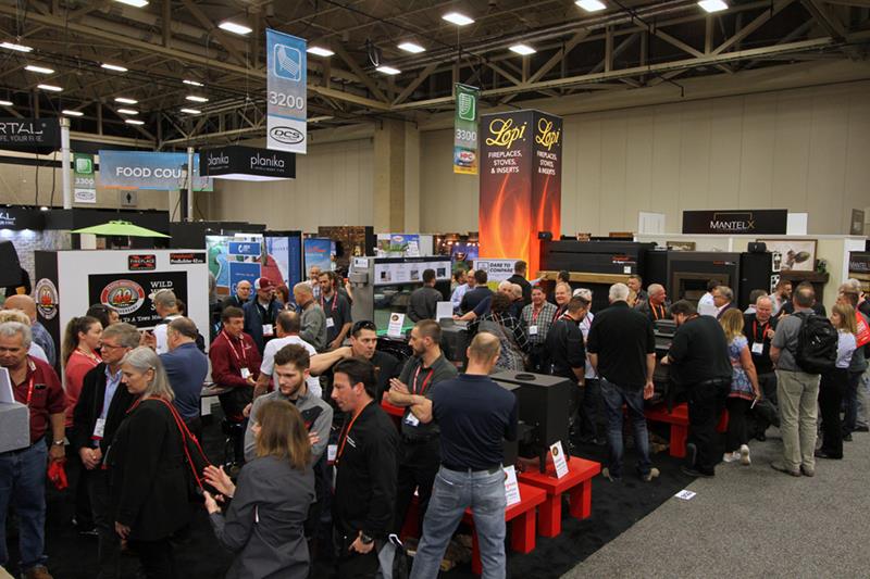 Attendees crowd hearth product booths on the HPBExpo trade show floor